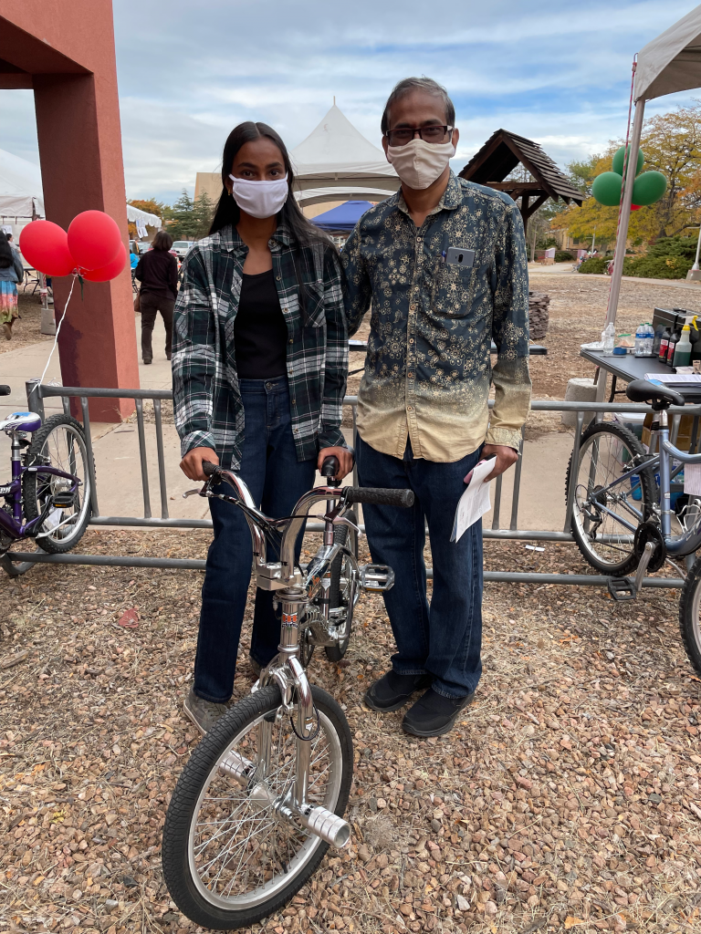 Two people holding a bicycle